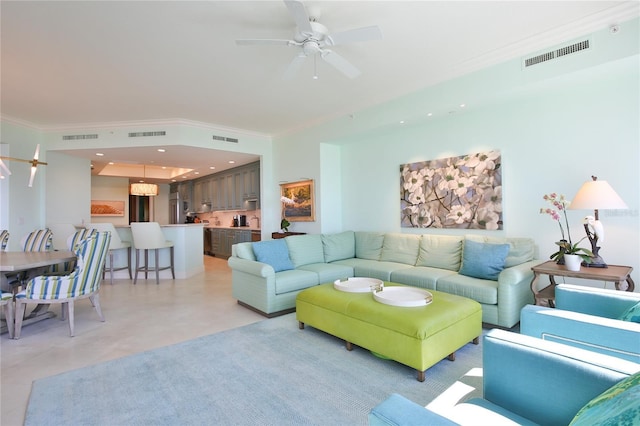 living room with visible vents and ornamental molding