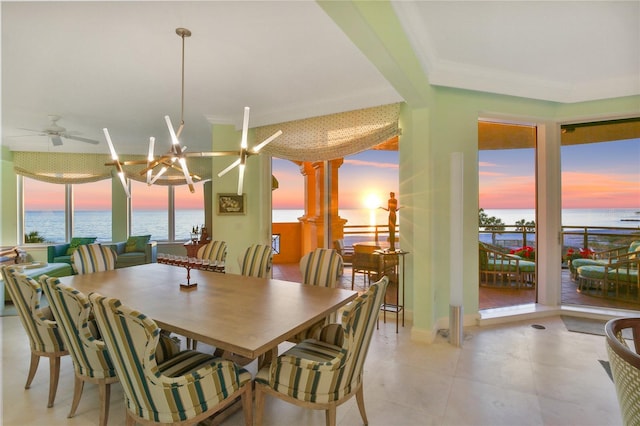 dining room with ornamental molding, a water view, and ceiling fan