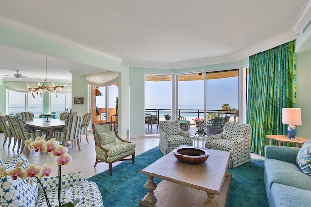 living area with crown molding, a notable chandelier, and a water view