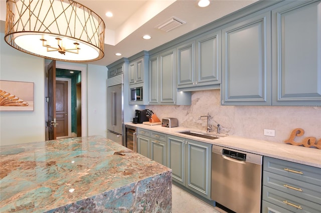 kitchen with visible vents, a sink, wine cooler, built in appliances, and backsplash