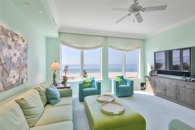 carpeted living area featuring baseboards, crown molding, and ceiling fan