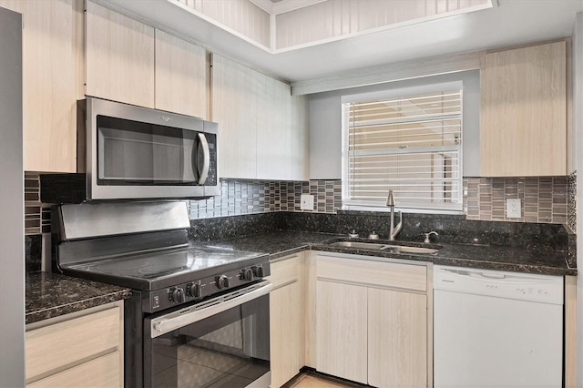 kitchen featuring appliances with stainless steel finishes, sink, and light brown cabinets