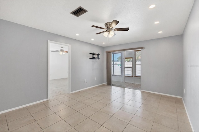 tiled empty room featuring ceiling fan