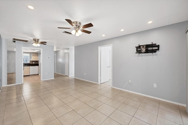 spare room featuring light tile patterned flooring and ceiling fan