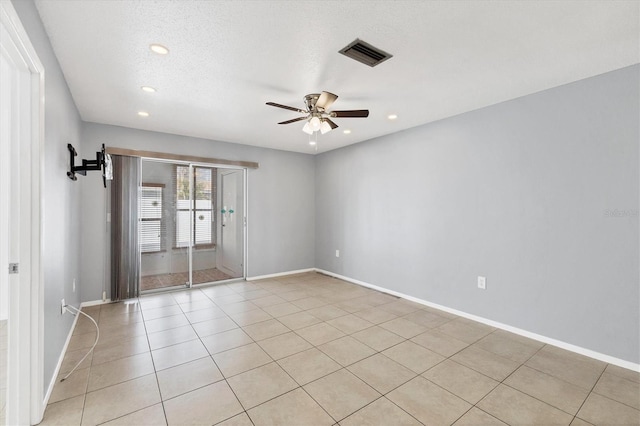 unfurnished room with light tile patterned floors, a textured ceiling, and ceiling fan