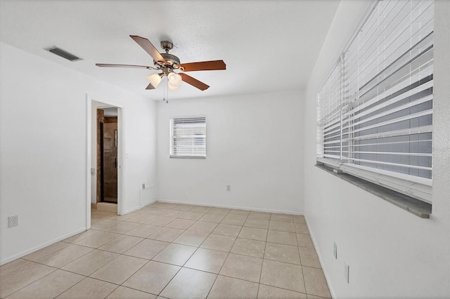 tiled empty room with ceiling fan