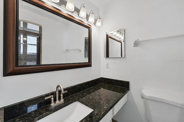 bathroom featuring vanity and toilet