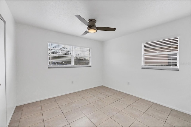 spare room with ceiling fan and a textured ceiling