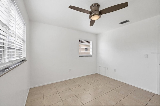 spare room featuring light tile patterned floors and ceiling fan
