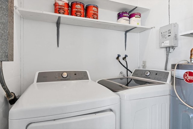 washroom featuring water heater and washer and dryer