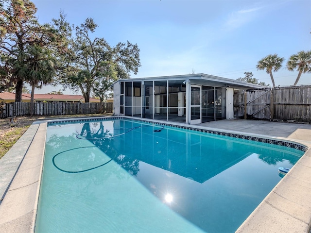 view of swimming pool featuring a sunroom