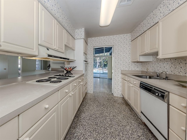 kitchen featuring white cabinetry, sink, and white appliances