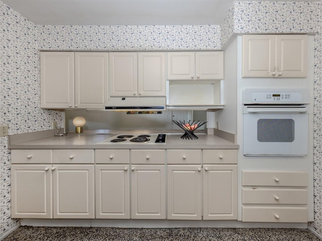 kitchen with white cabinetry and white appliances