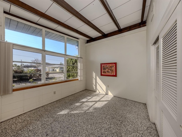 empty room with beam ceiling