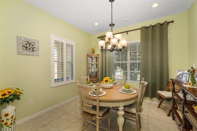 dining room with light tile patterned floors and a chandelier