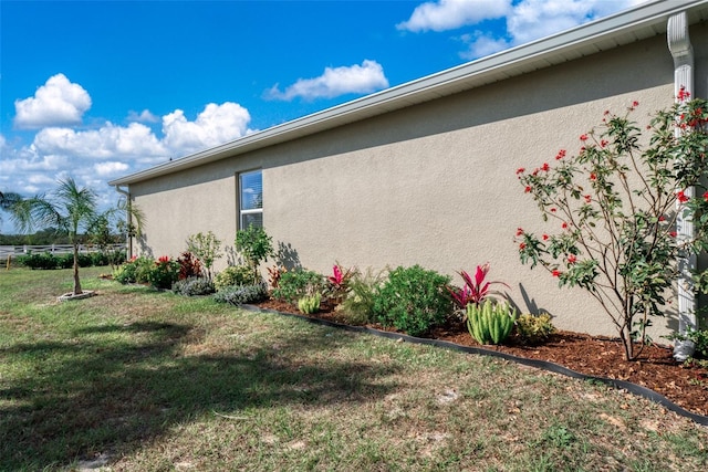 view of property exterior with a yard