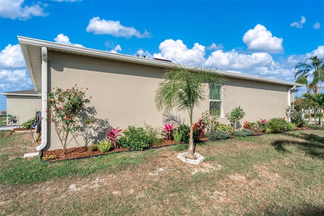 view of side of home featuring a lawn