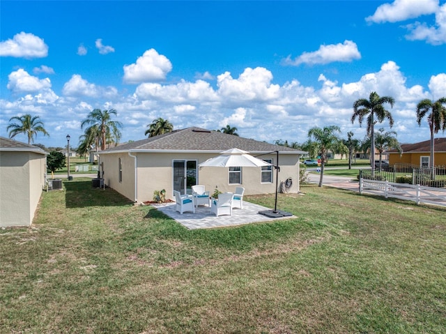 back of house with a yard, a patio area, and central AC