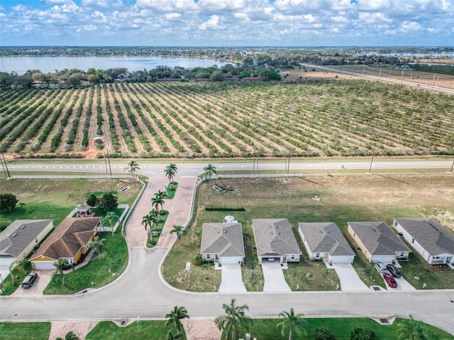 birds eye view of property featuring a water view and a rural view