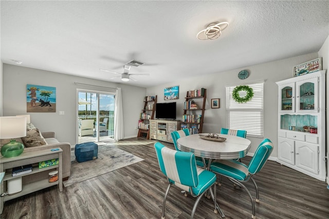 dining area featuring ceiling fan, dark hardwood / wood-style floors, and a textured ceiling