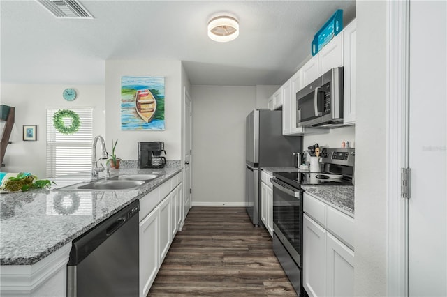 kitchen featuring sink, stainless steel appliances, white cabinets, and light stone countertops