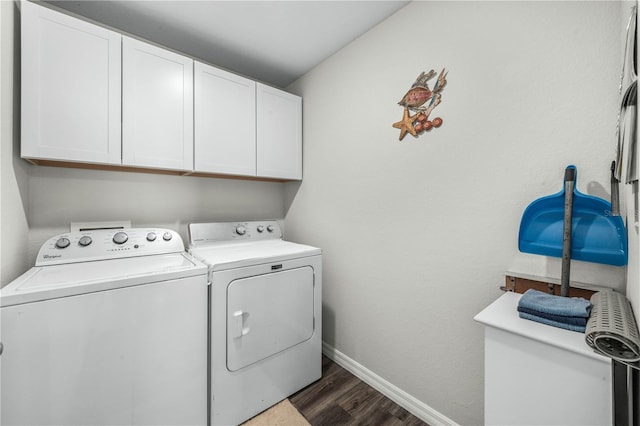 laundry room with cabinets, washer and dryer, and dark wood-type flooring