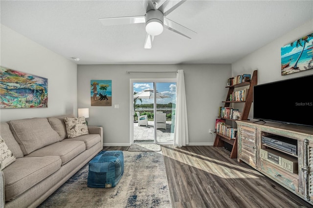 living room with ceiling fan, hardwood / wood-style floors, and a textured ceiling