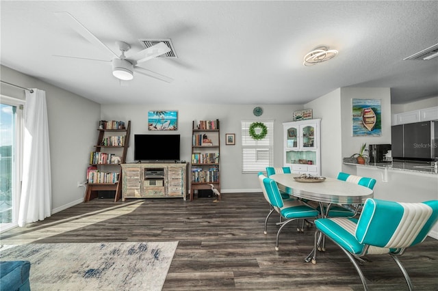 dining area featuring ceiling fan, dark hardwood / wood-style flooring, and a textured ceiling