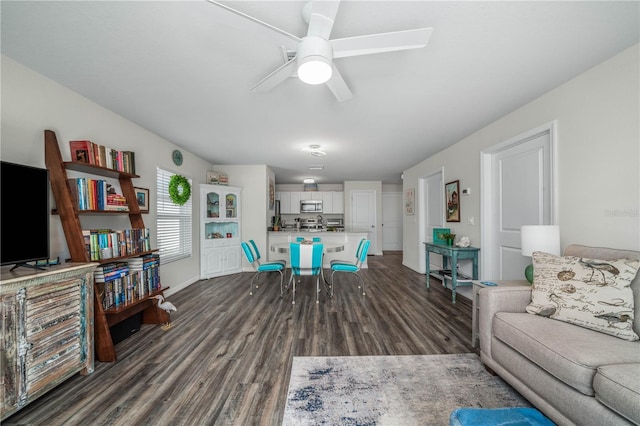 living room featuring dark hardwood / wood-style flooring and ceiling fan