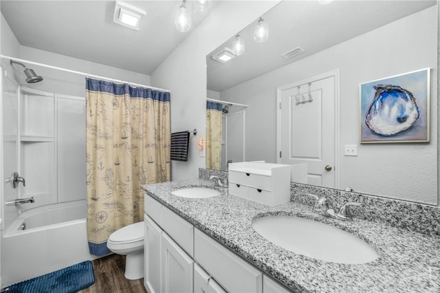 full bathroom featuring hardwood / wood-style flooring, shower / tub combo with curtain, vanity, and toilet