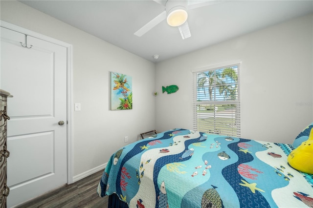 bedroom with dark hardwood / wood-style flooring and ceiling fan