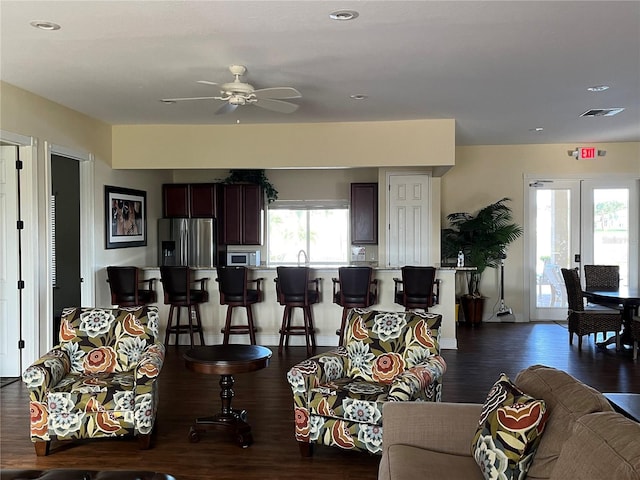 living room with dark hardwood / wood-style floors, ceiling fan, and french doors