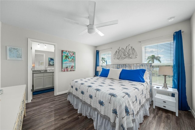 bedroom featuring ensuite bath, a ceiling fan, baseboards, and dark wood-style flooring