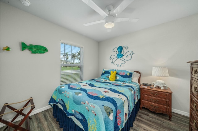 bedroom featuring baseboards, a ceiling fan, and wood finished floors