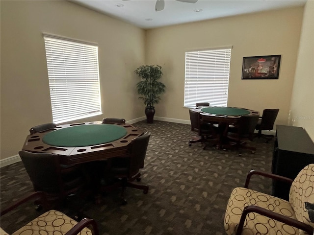 playroom featuring baseboards, dark carpet, and ceiling fan