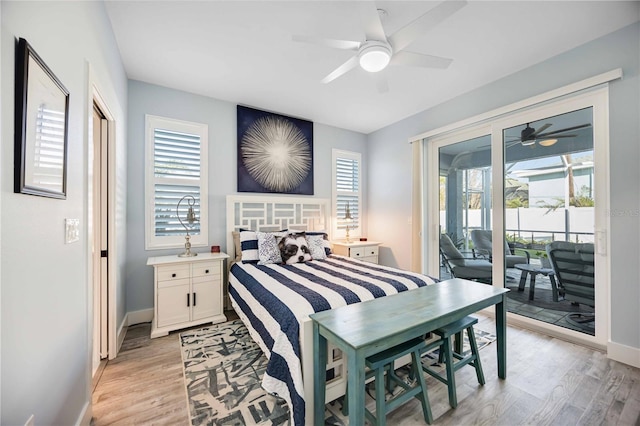 bedroom featuring light wood-type flooring, multiple windows, and access to outside