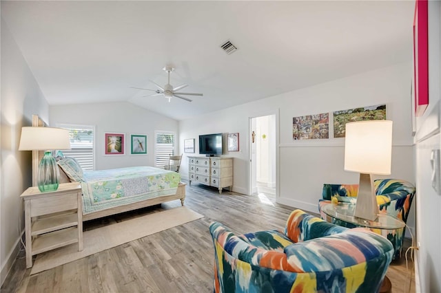 bedroom with vaulted ceiling, ceiling fan, and light hardwood / wood-style flooring