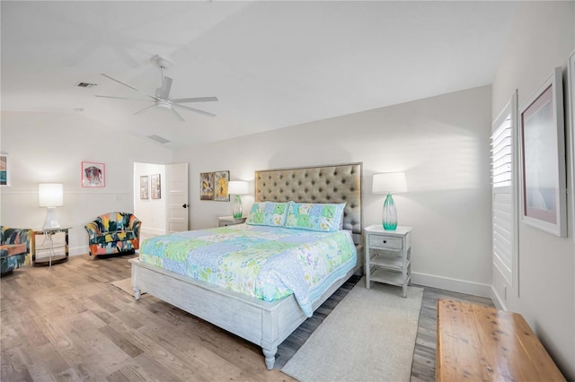 432 W Gate Dr, Venice, FL 34285 - bedroom with baseboards, vaulted ceiling, visible vents, and wood finished floors
