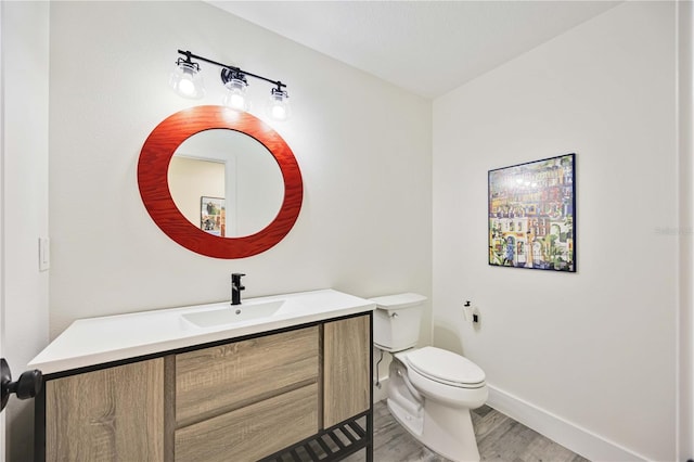 432 W Gate Dr, Venice, FL 34285 - bathroom with toilet, baseboards, vanity, and wood finished floors