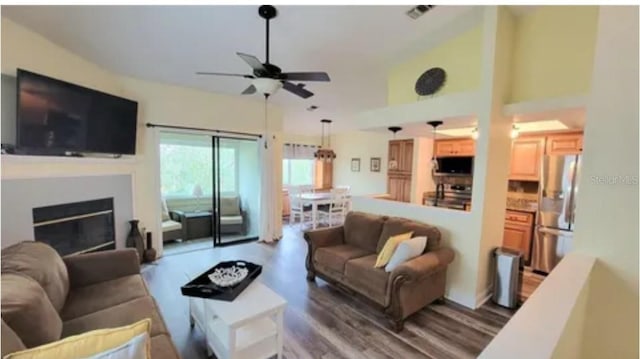 living room featuring wood-type flooring and ceiling fan