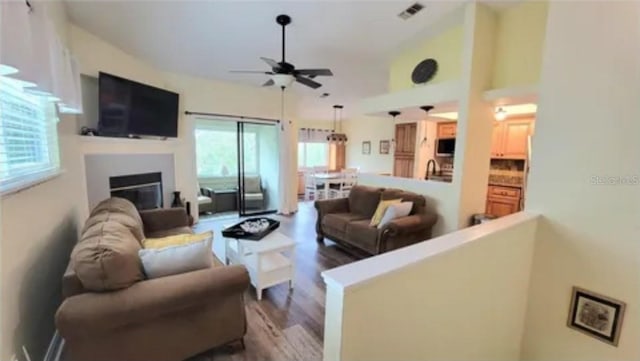 living room with hardwood / wood-style flooring and ceiling fan