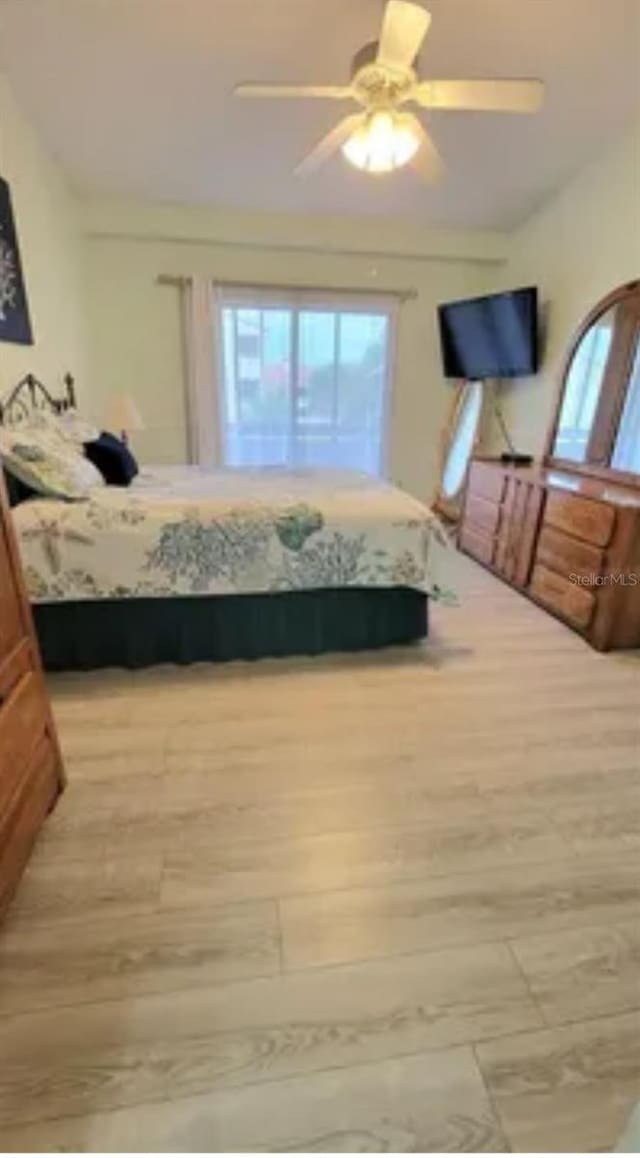 bedroom with ceiling fan and light hardwood / wood-style flooring