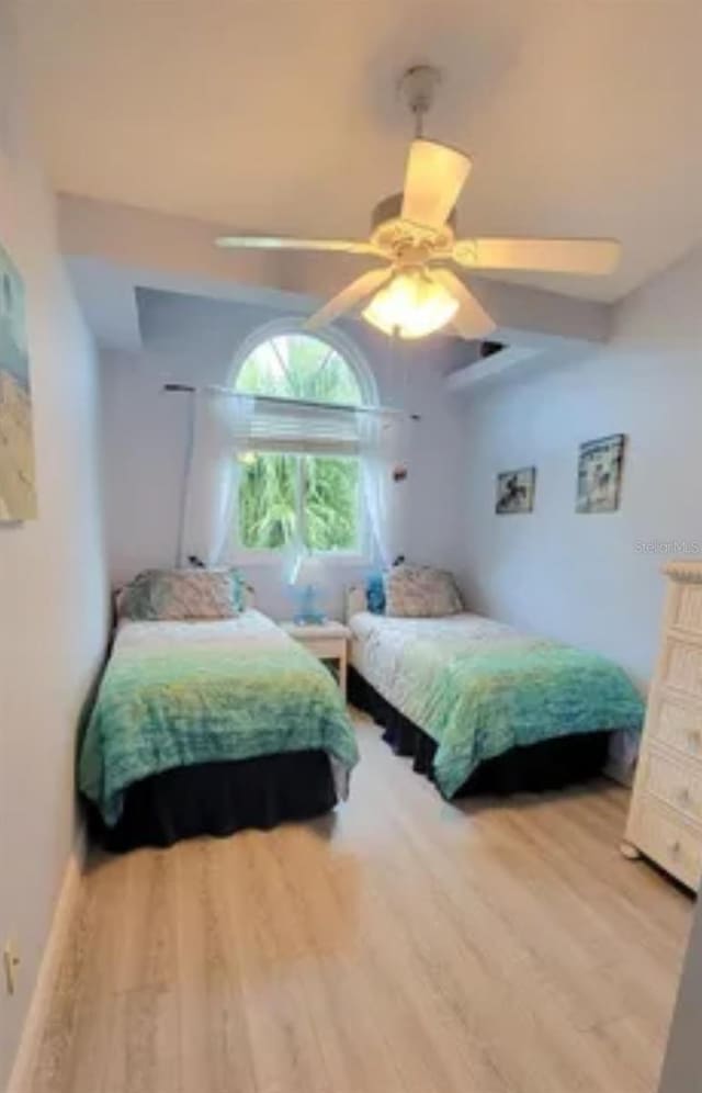 bedroom with hardwood / wood-style floors and ceiling fan