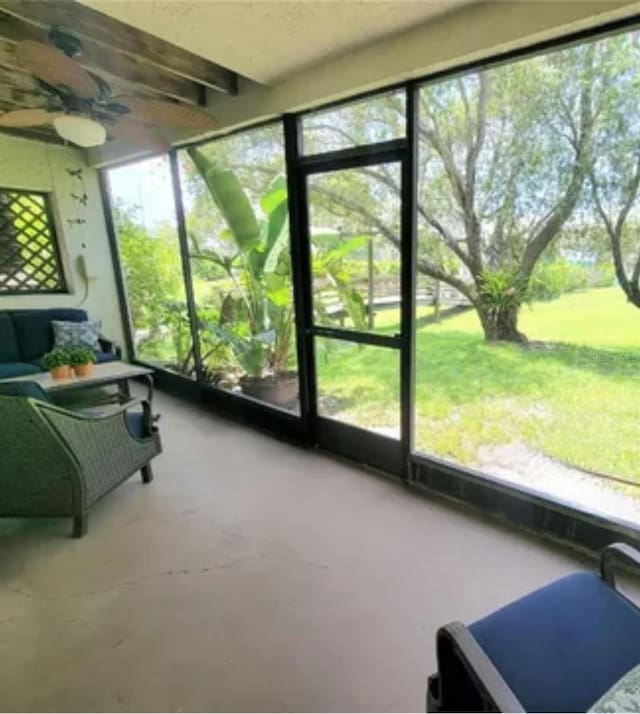 sunroom featuring ceiling fan