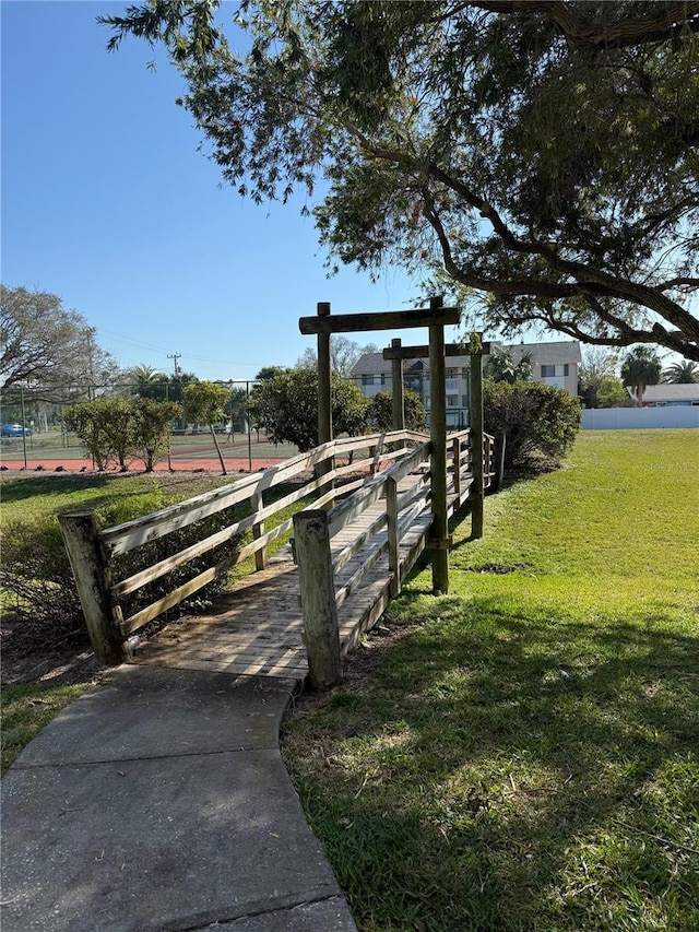 view of property's community featuring a yard