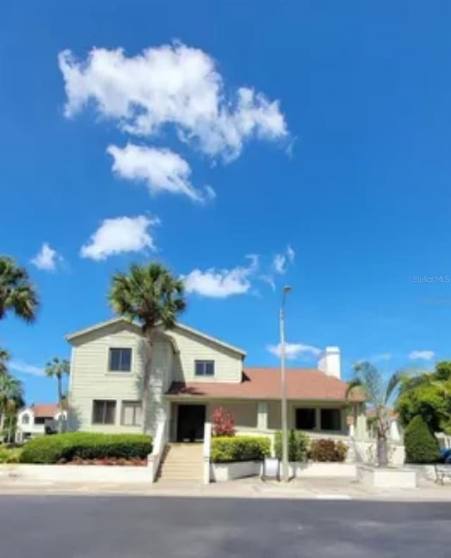 625 Duchess Blvd, Dunedin, FL 34698 - view of front of house featuring a chimney