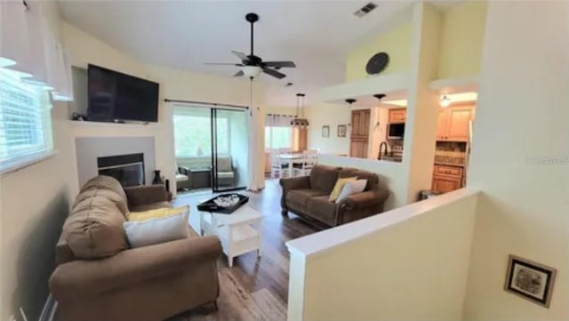 625 Duchess Blvd, Dunedin, FL 34698 - living area featuring ceiling fan, dark wood-style floors, and a glass covered fireplace