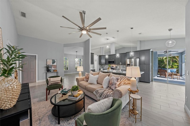 living room with high vaulted ceiling, sink, and ceiling fan