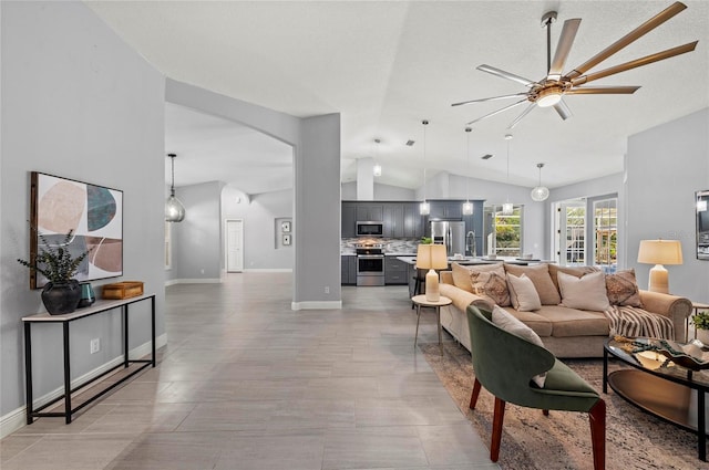 living room featuring lofted ceiling, sink, and ceiling fan