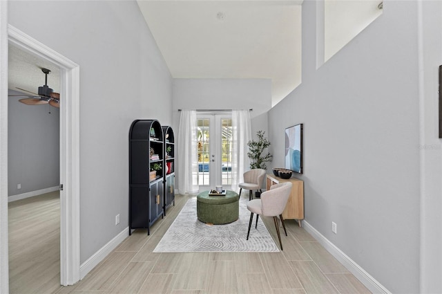 living area featuring french doors and ceiling fan